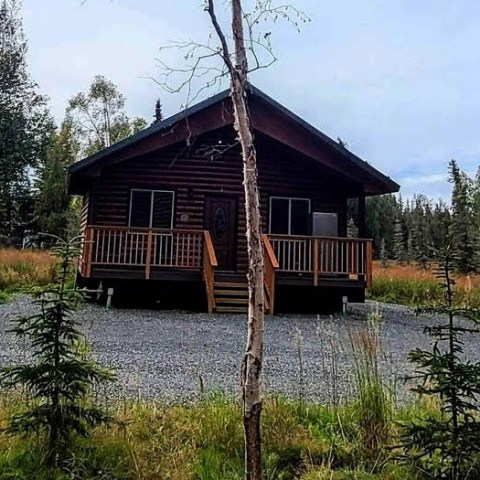 a small house surrounded by trees