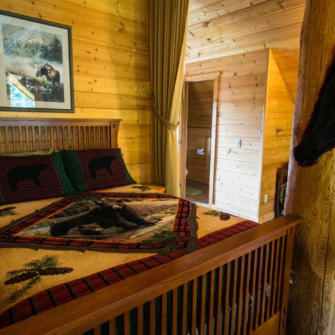 a bedroom with a bed and a fireplace