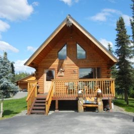a small clock tower in front of a house