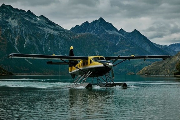 a small boat in a body of water with a mountain in the background