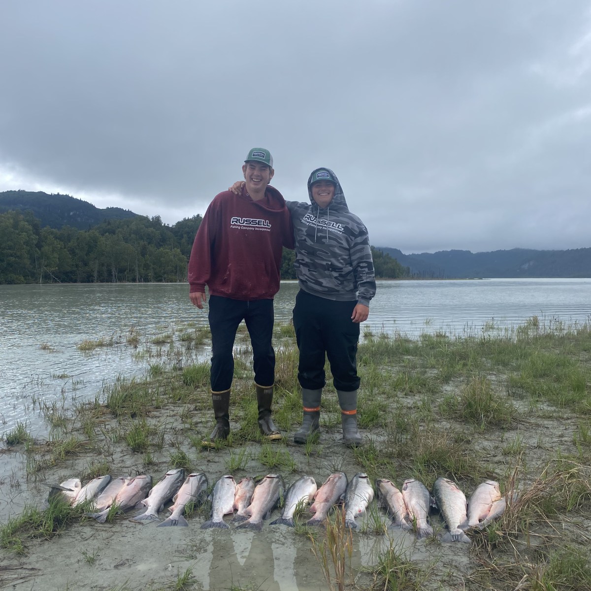 a man standing next to a body of water