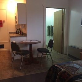 a living room filled with furniture and a large window