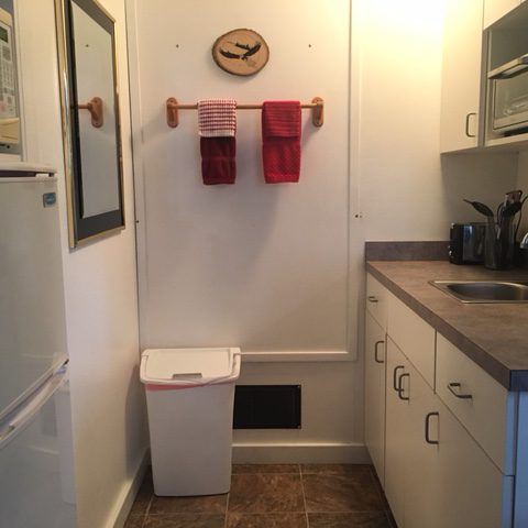 a kitchen with a sink and a refrigerator