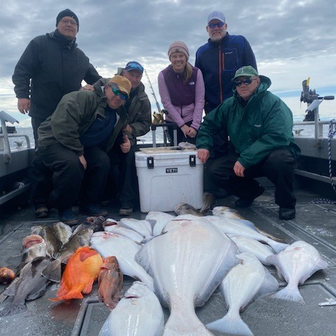 a group of people standing in front of a fish