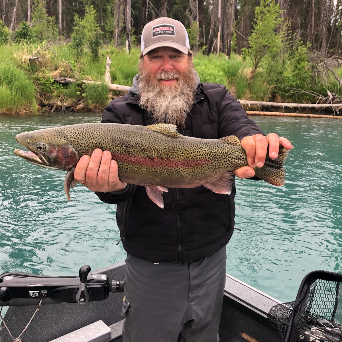 a man holding a fish in the water