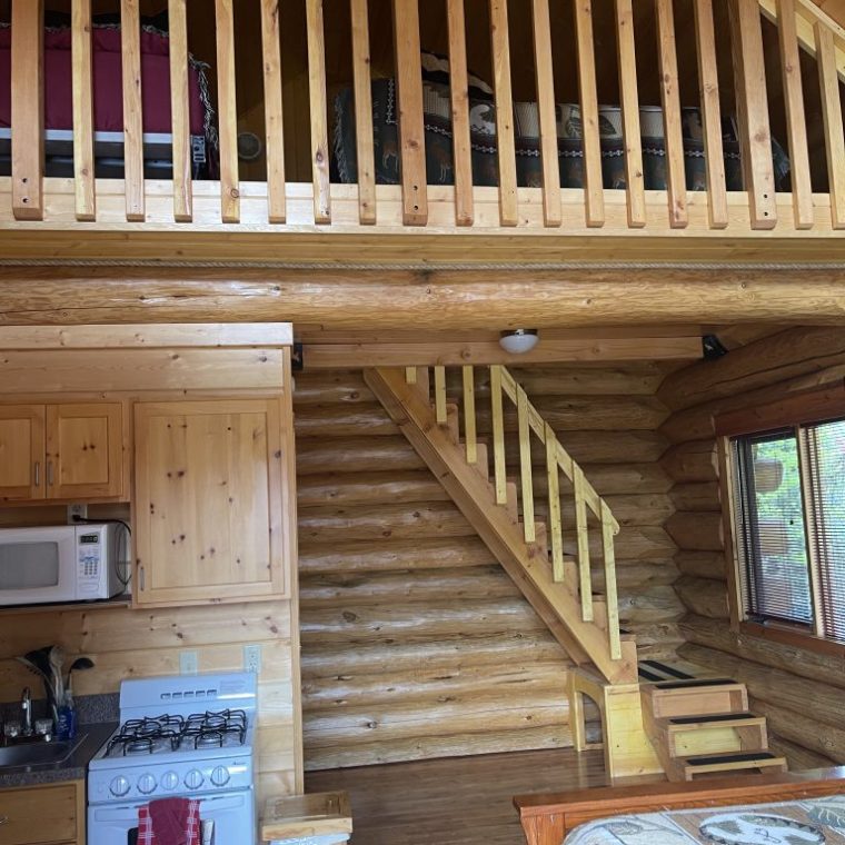 a wooden bench sitting next to a fireplace